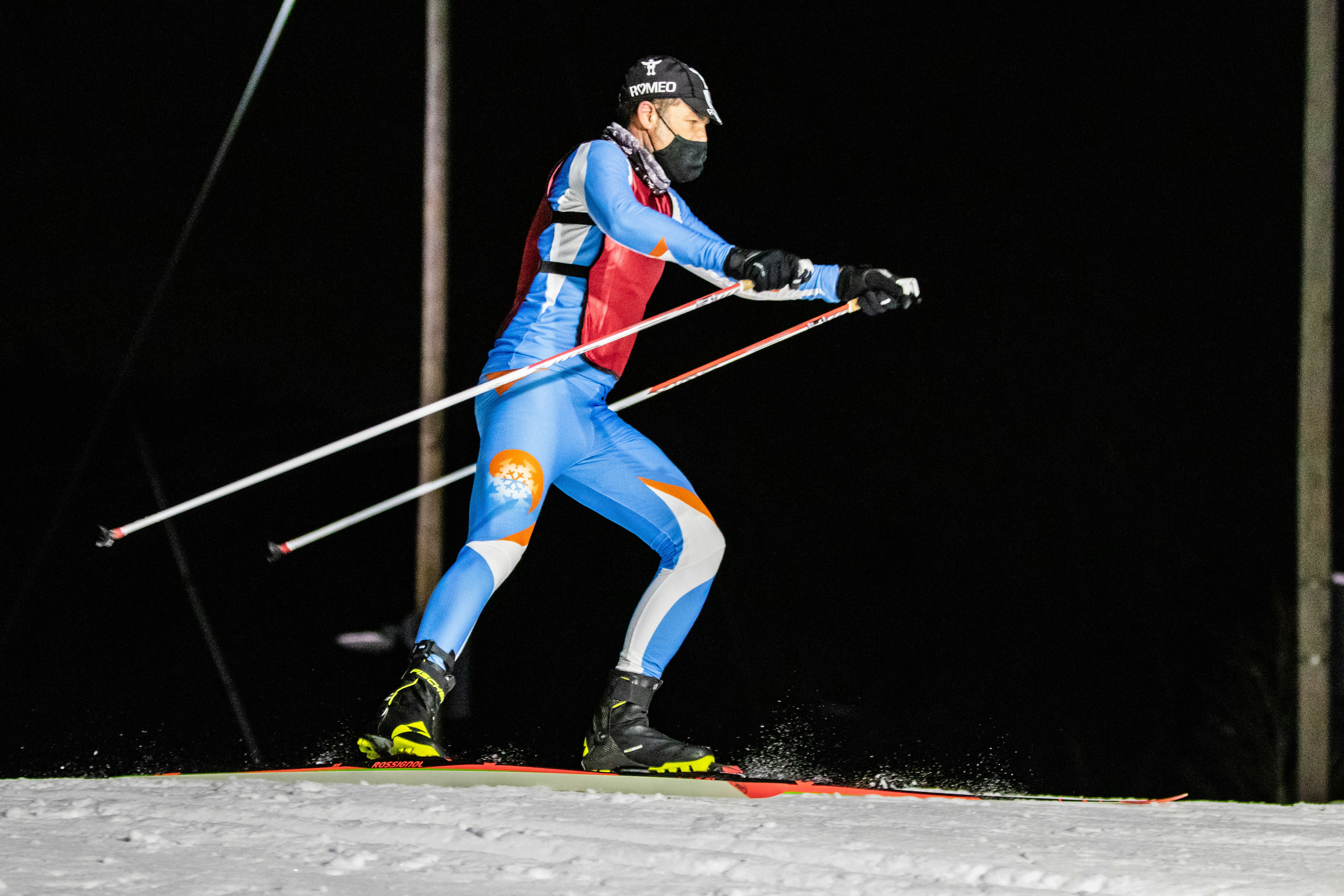 man in blue and red jacket and blue pants riding on snowboard