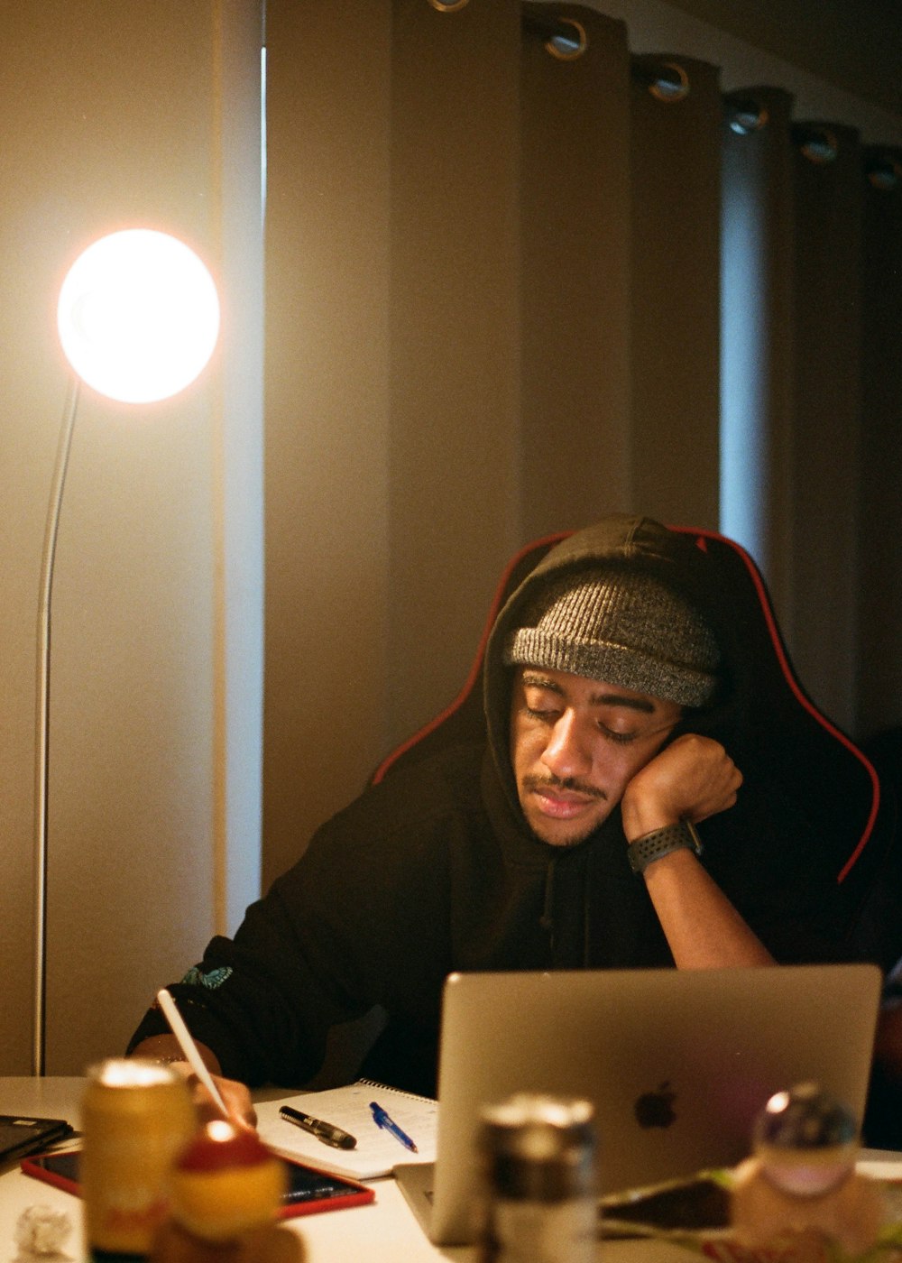 man in black hoodie using macbook