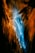 A vibrant abstract image featuring a dynamic interplay of colors. Bright blue tones flow through the center, surrounded by rich shades of orange and black creating an effect reminiscent of a flowing river or waterfall in vibrant motion.