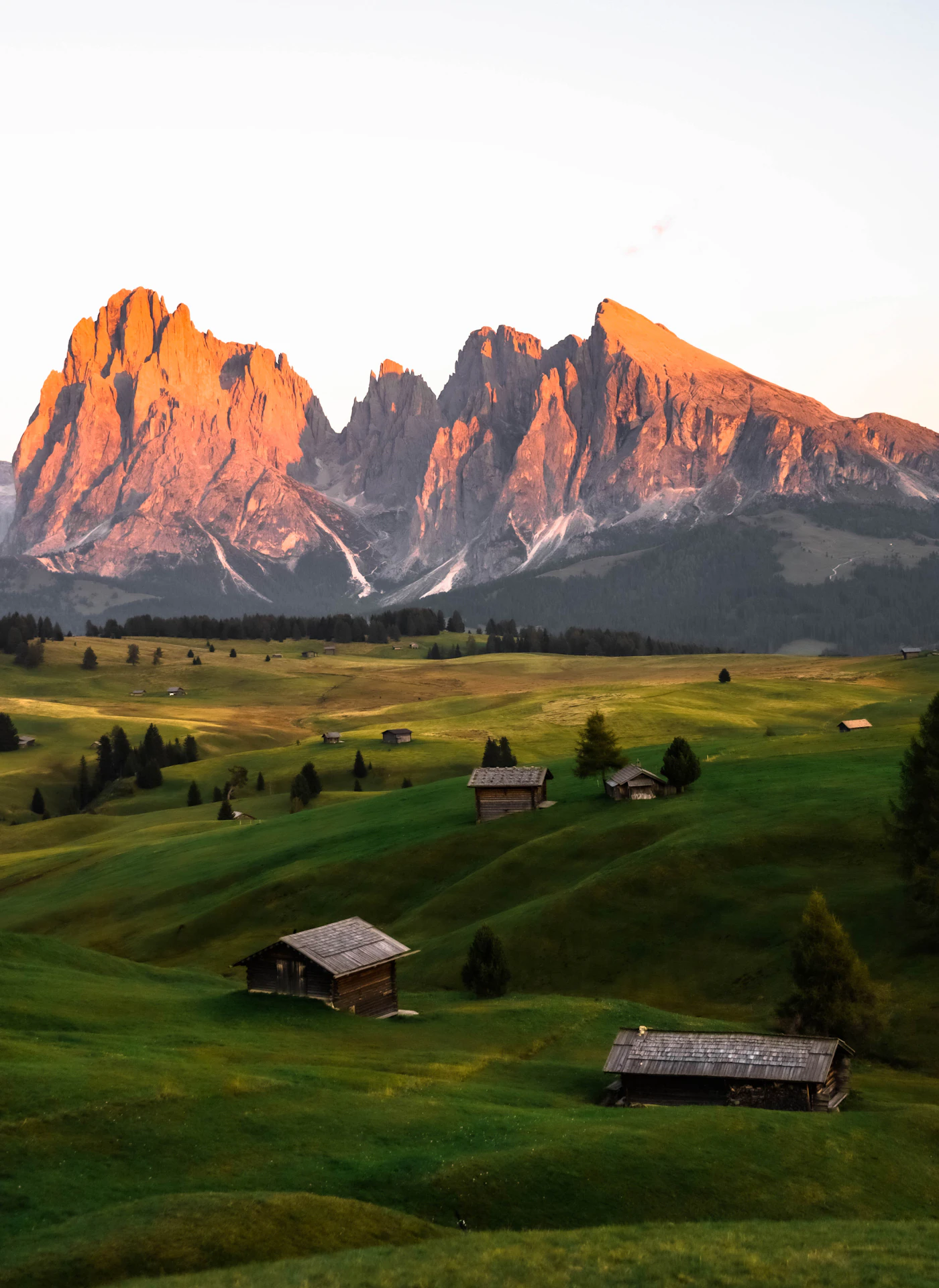 Traditional alpine wooden lodge beneath Dolomite peaks