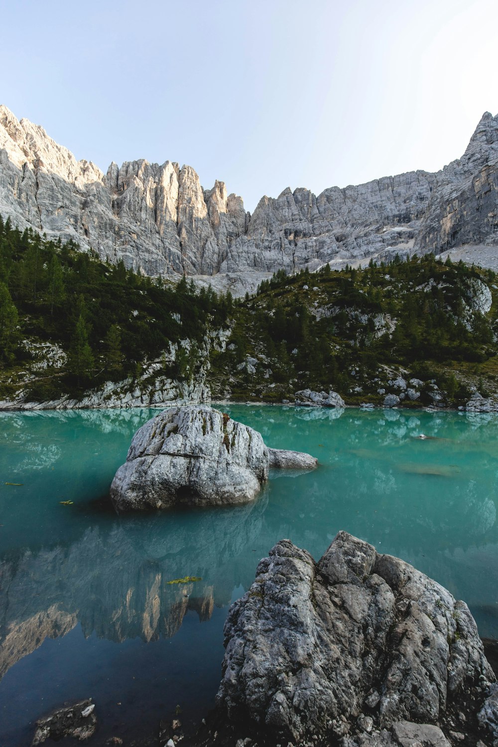 body of water near mountain during daytime