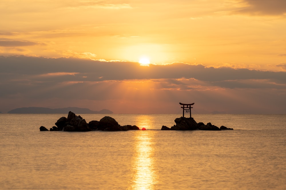 the sun is setting over a body of water