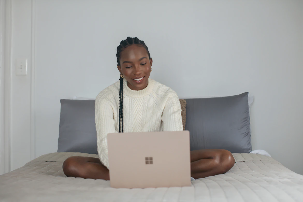 Person in white shirt using laptop