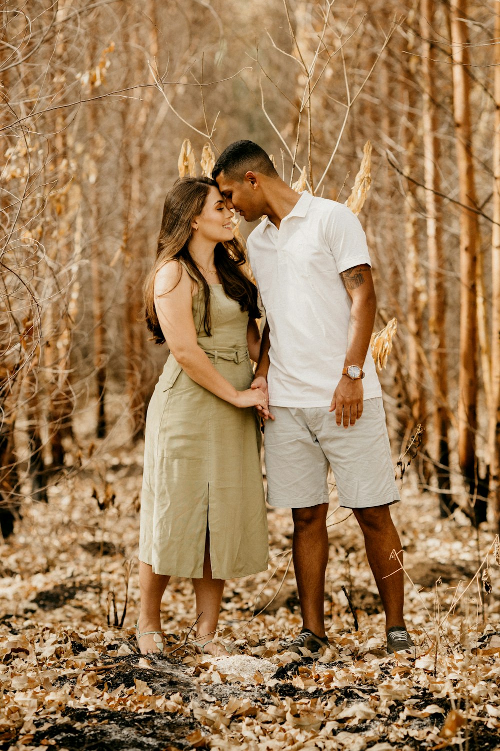 man and woman kissing on the woods during daytime