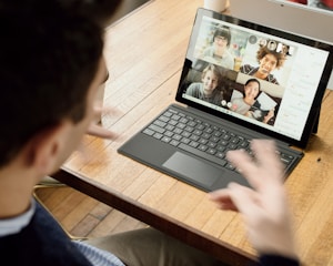 person in blue long sleeve shirt using black Surface