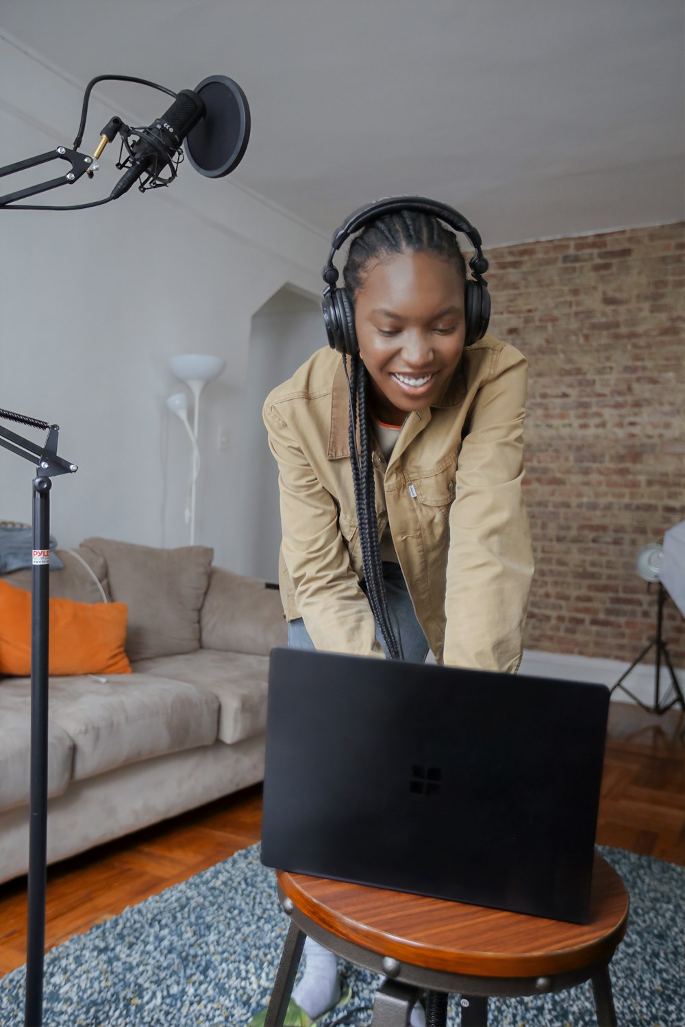 person in beige jacket using Surface device