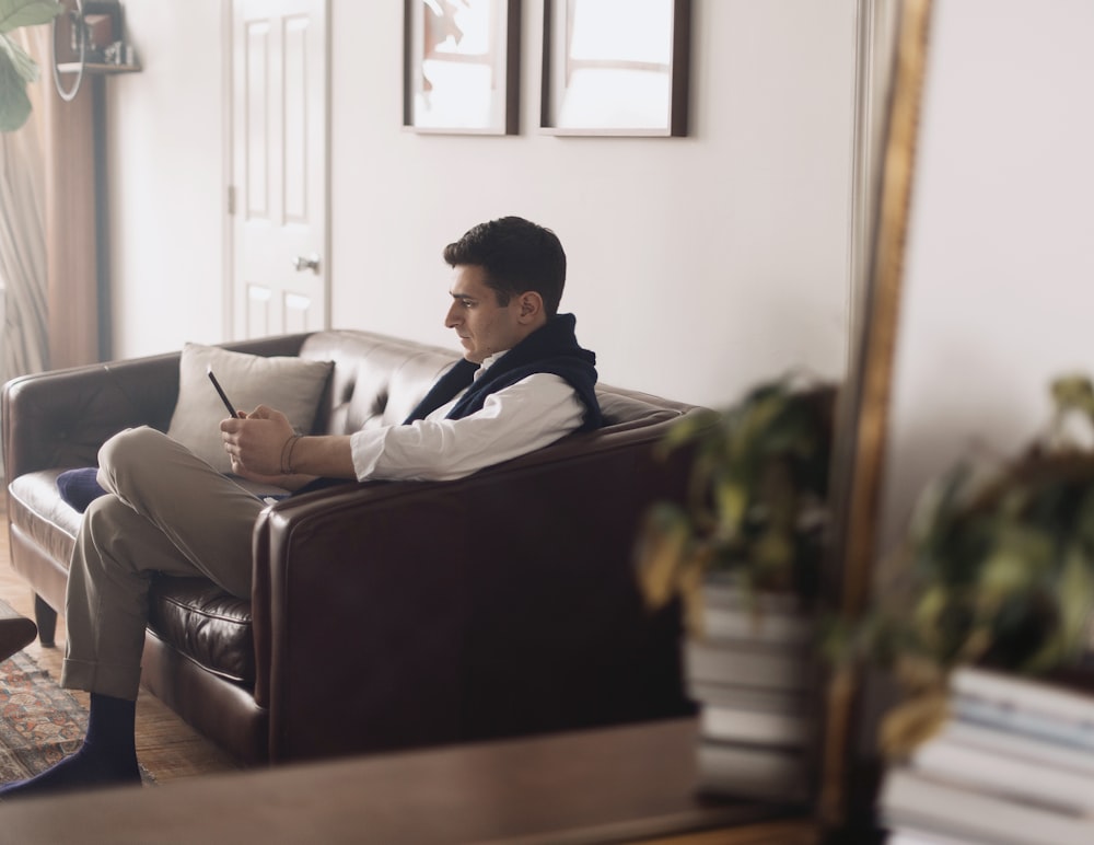 man sitting on brown couch