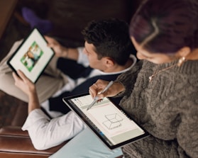 Team collaborating over digital tablets with integrated system visuals.