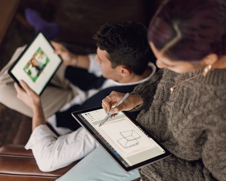 Construction workers collaborating on a building site with digital tablets.