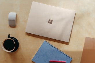 A serene workspace with a laptop, notebook, and coffee cup, symbolizing creativity and focus.
