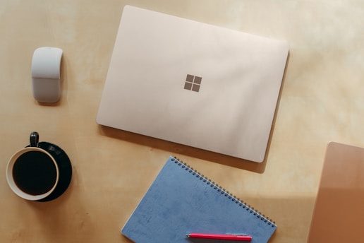 A serene workspace with a laptop, notebook, and a cup of coffee, symbolizing productivity and creativity.