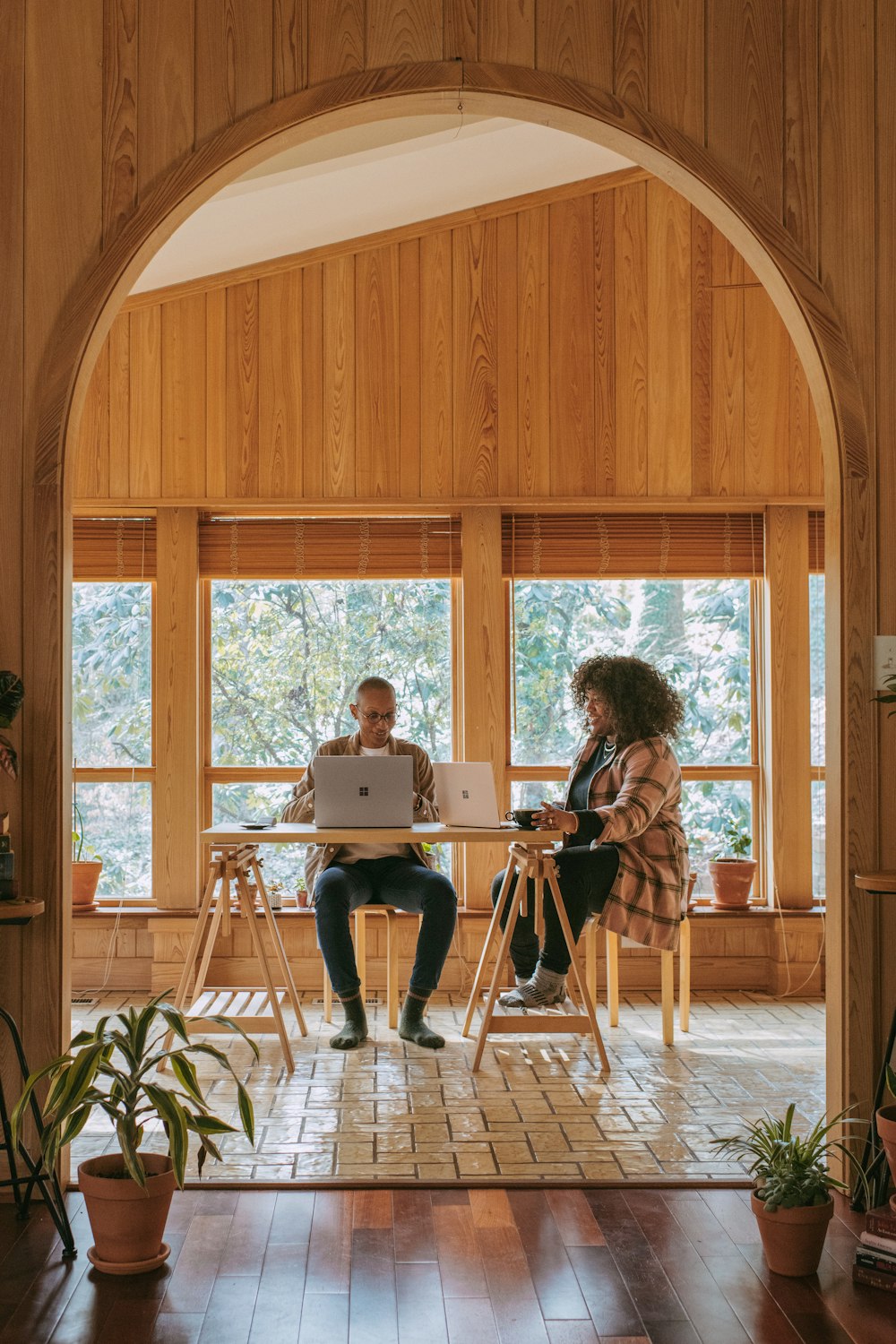 people sitting on chair in front of table