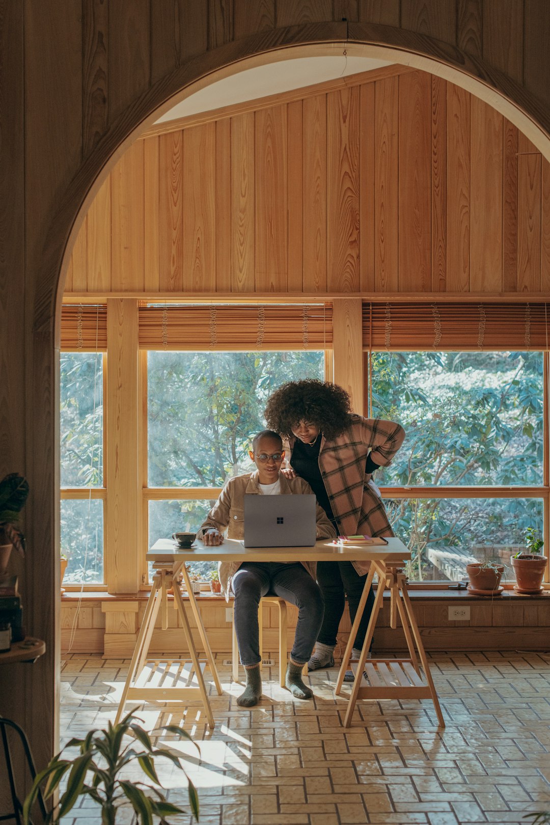 person sitting on chair in front of table with Surface device