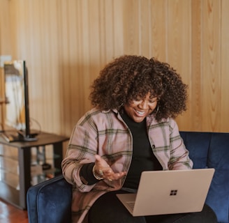 person sitting on couch holding a Surface device