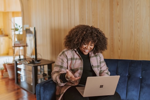 person sitting on couch holding a Surface device