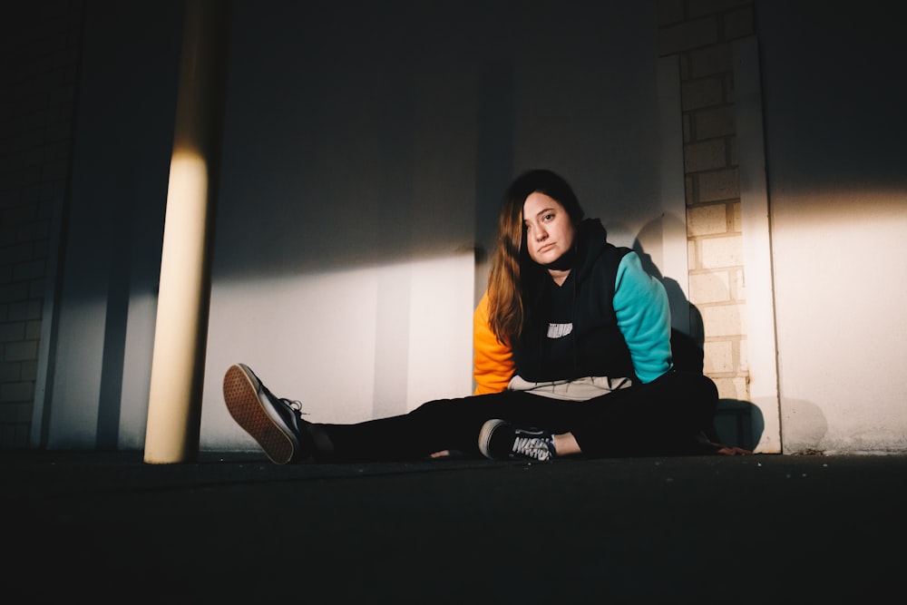 woman in green long sleeve shirt sitting on black table