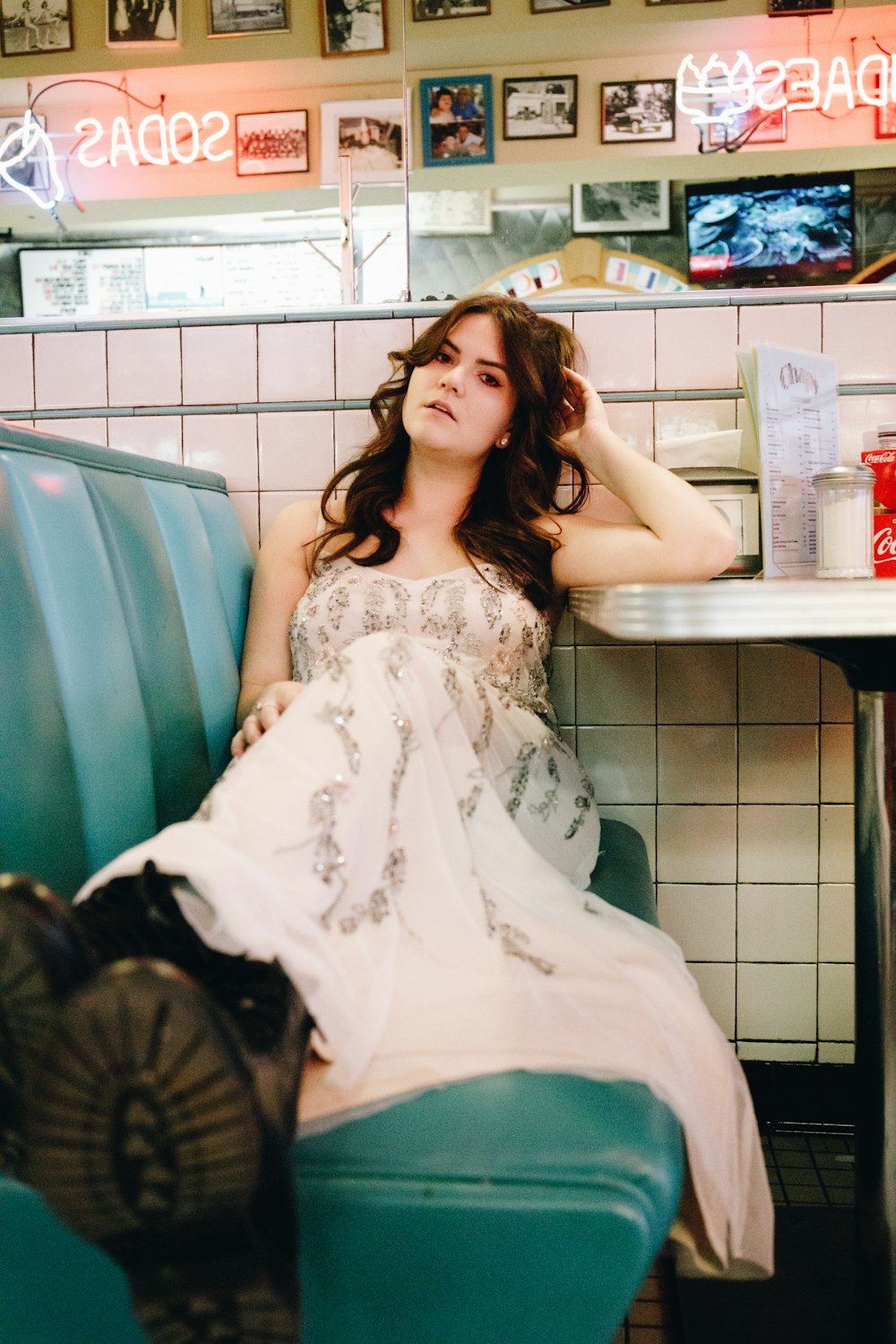 woman in white floral dress sitting on chair