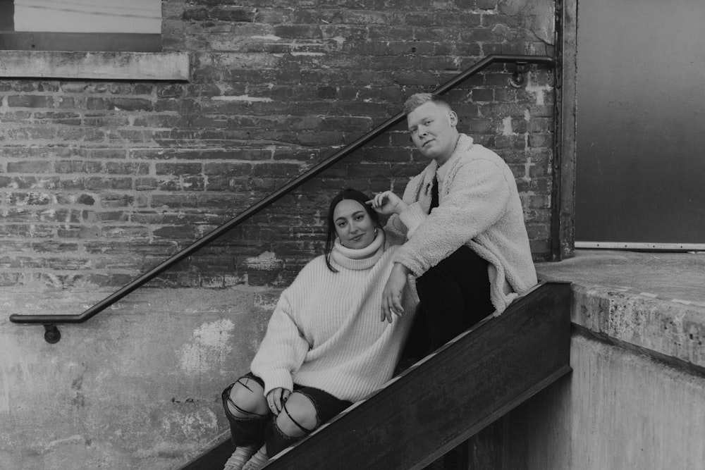 woman in white sweater and black pants sitting on wooden bench