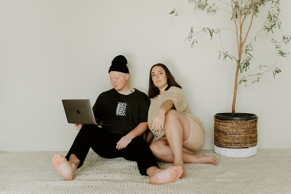 man and woman sitting on floor