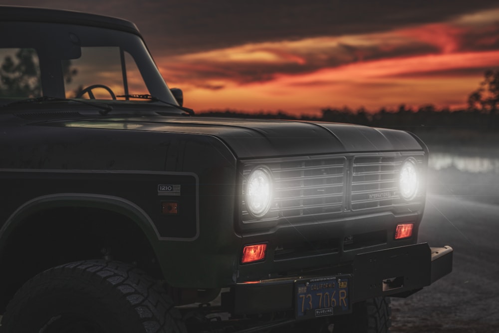 black suv on road during sunset