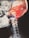 A detailed x-ray image of a human skull and neck with an overlay of bright red and orange colors highlighting muscular and tissue structures. The skeletal structure, including the vertebrae in the neck, is visible.