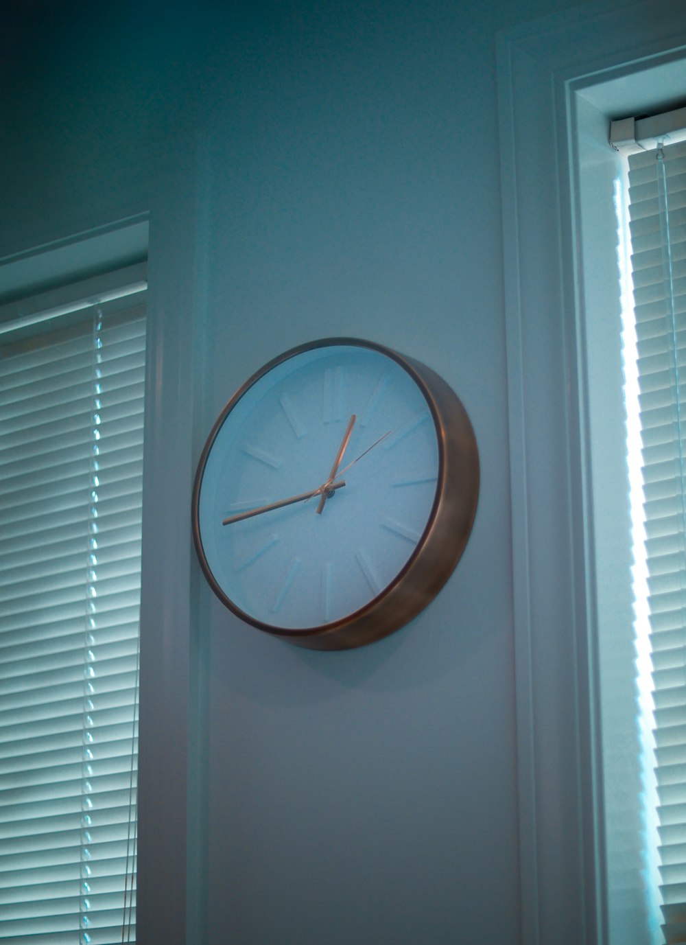 brown round analog wall clock at 11 00