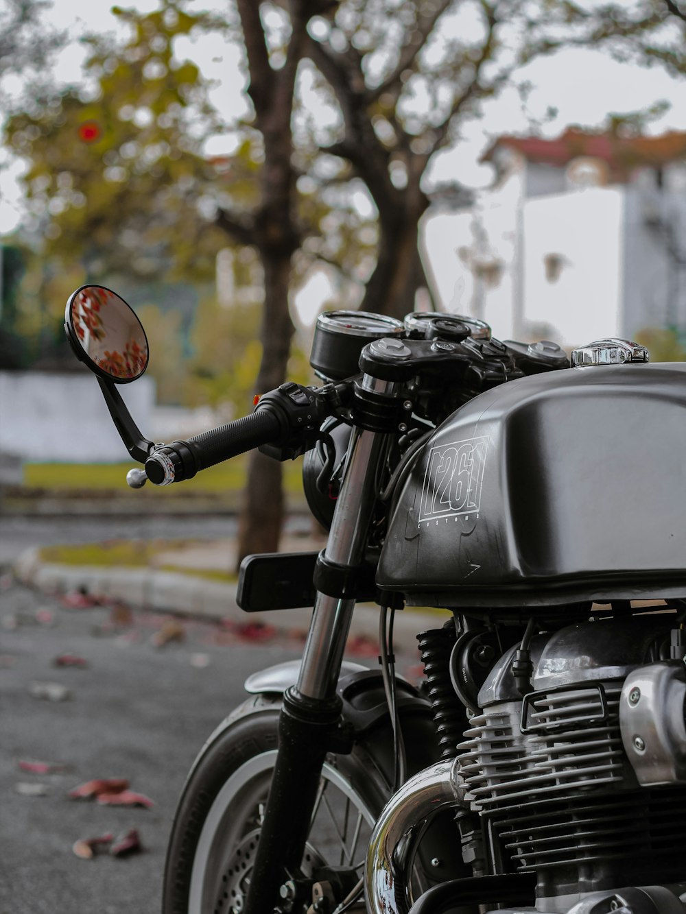 black motorcycle parked on the street during daytime