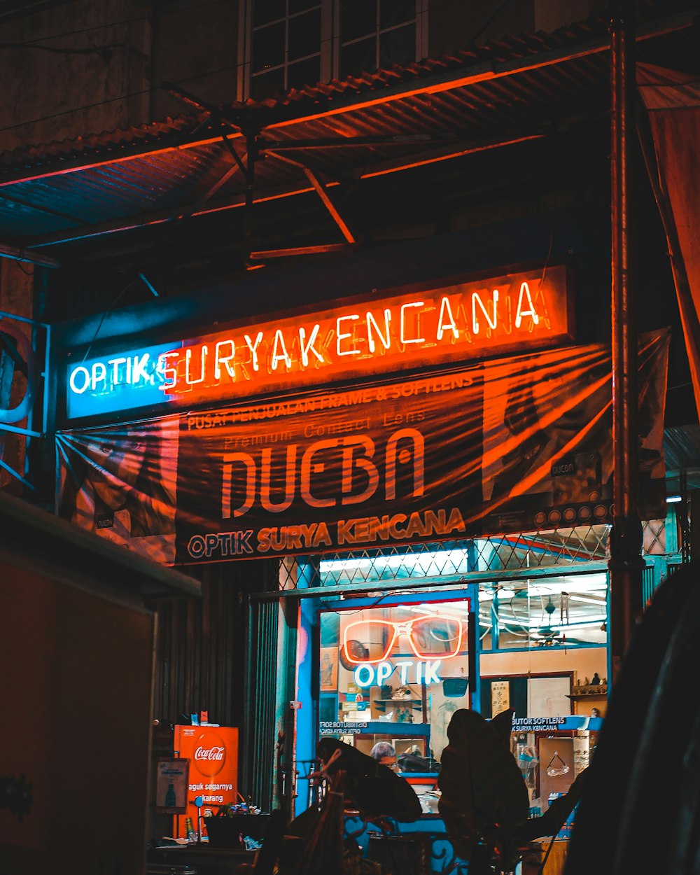 people standing in front of store during night time