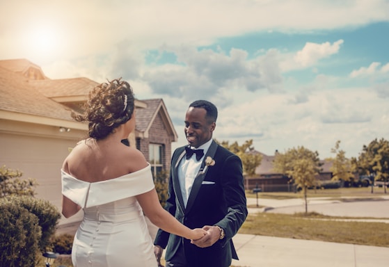 woman in white wedding dress holding man in black suit