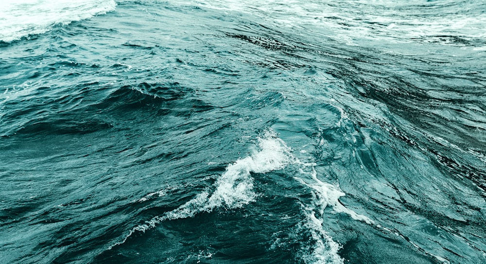 ocean waves crashing on shore during daytime