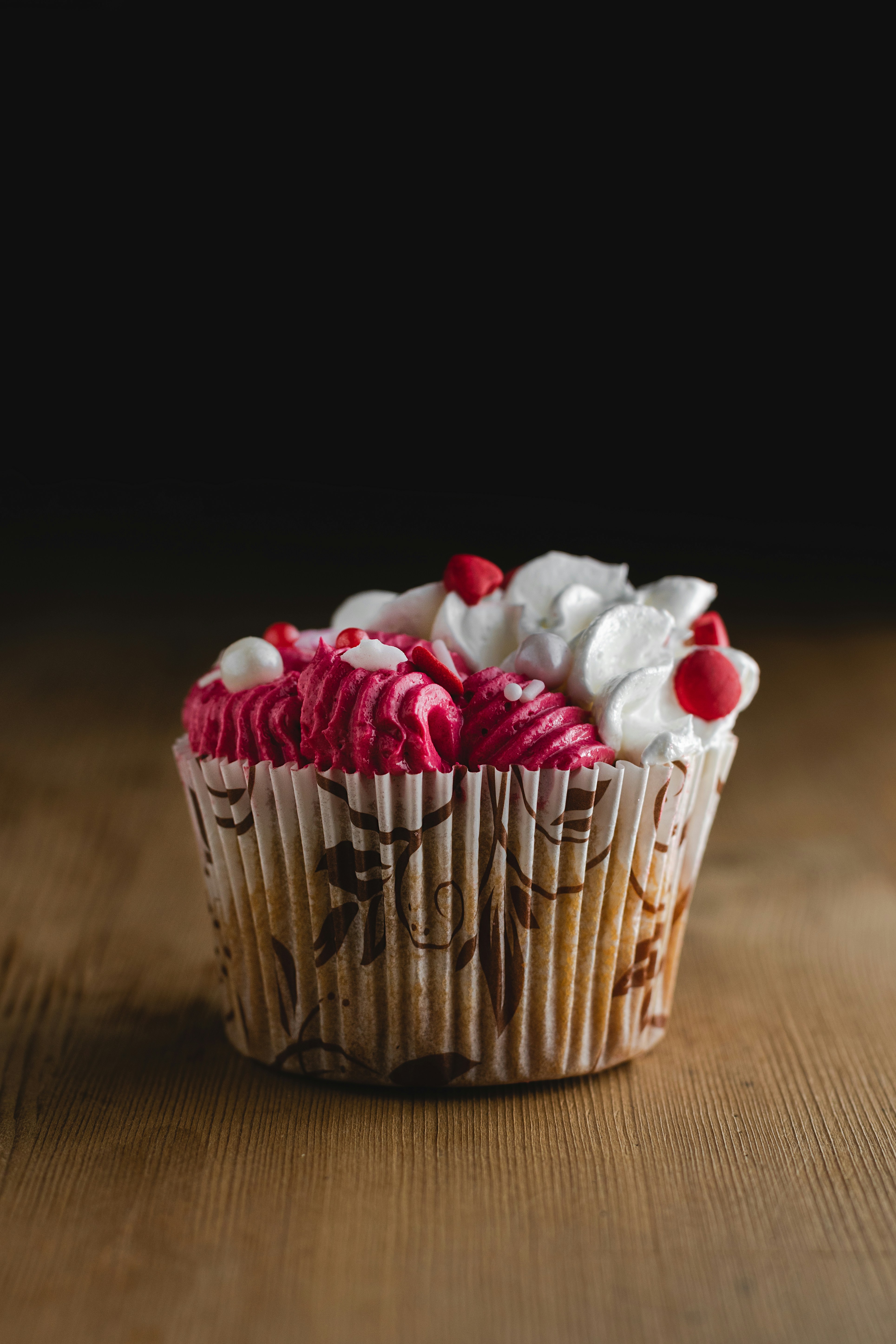 white and red heart candies on brown woven basket