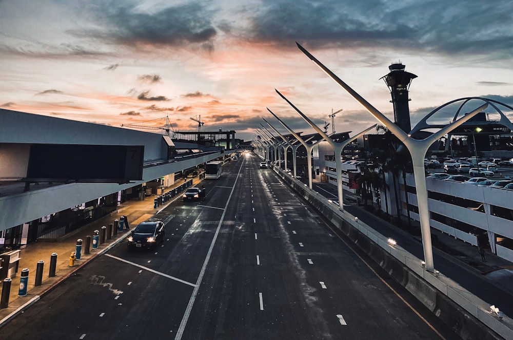 cars on road under cloudy sky during daytime