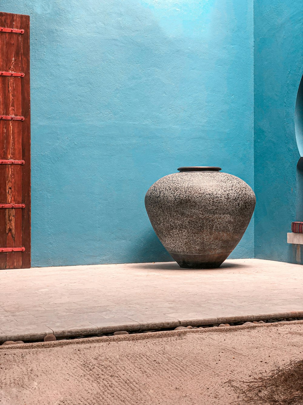 brown clay vase on white concrete surface