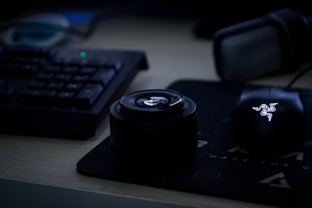 Schwarzes Kameraobjektiv auf schwarzem Laptop-Computer