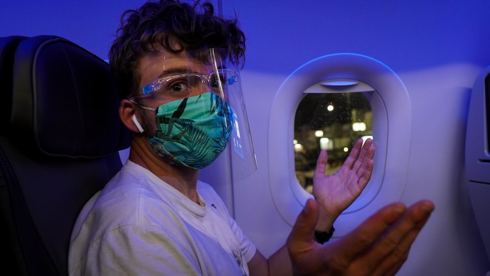 man in white shirt wearing green mask