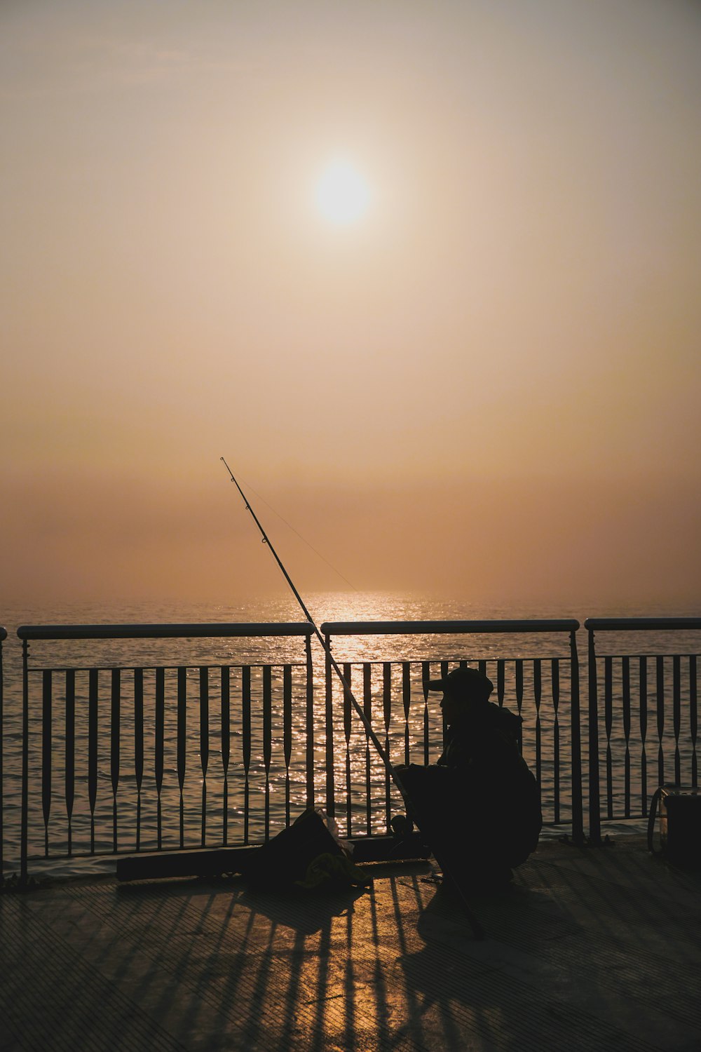 silhouette of person sitting on hammock during sunset