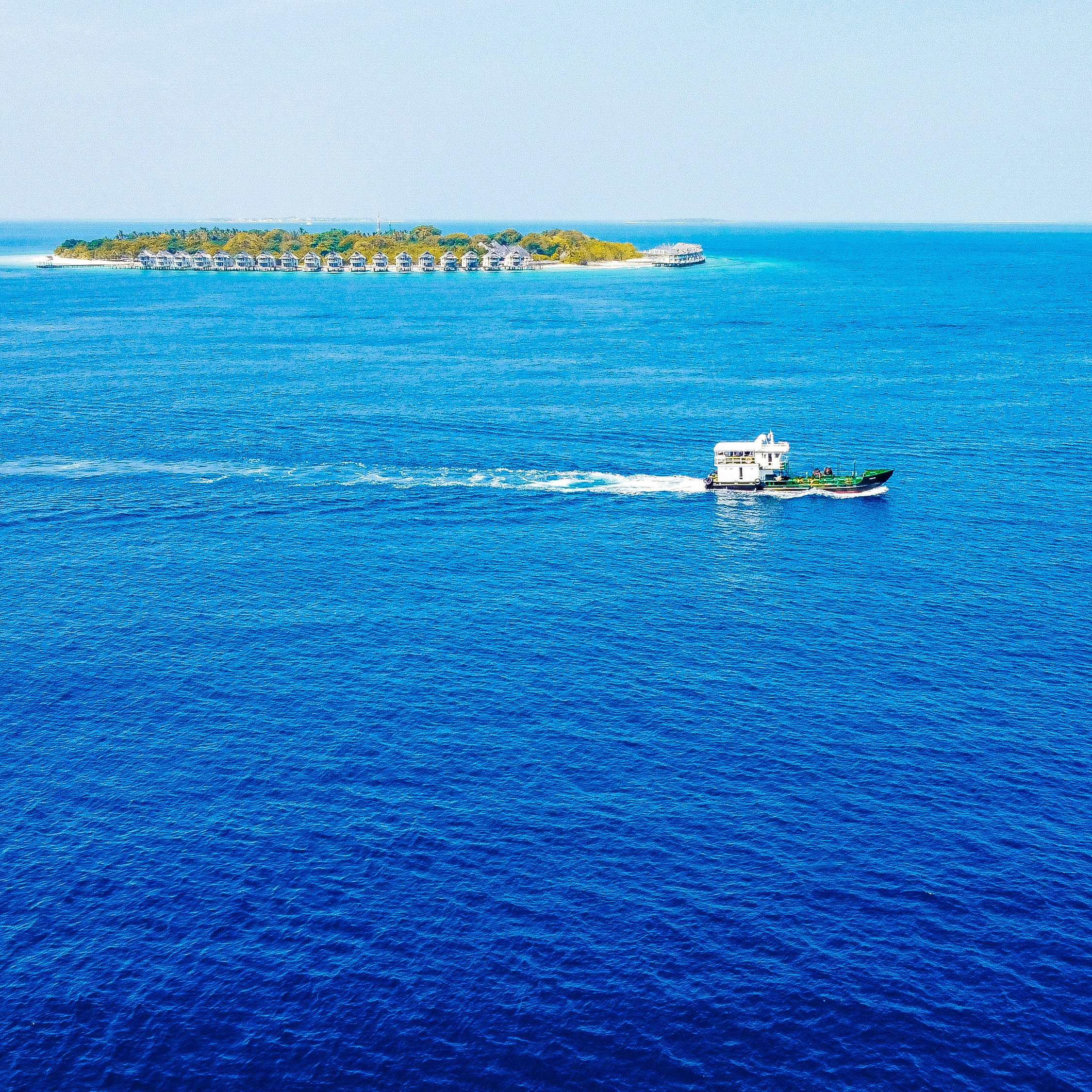 white and black boat on blue sea during daytime