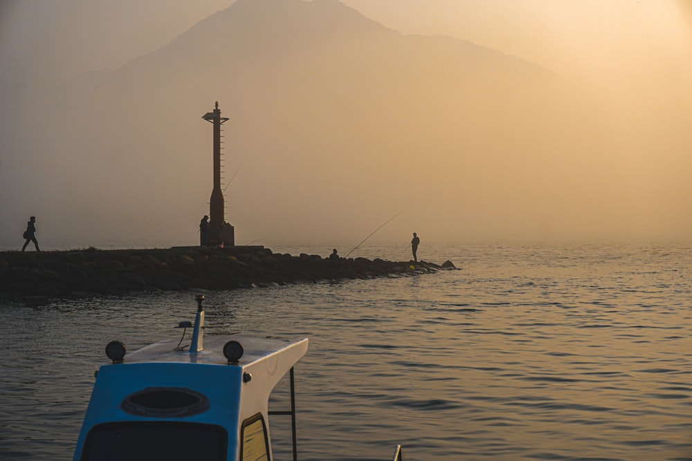 person in black shorts on boat during daytime