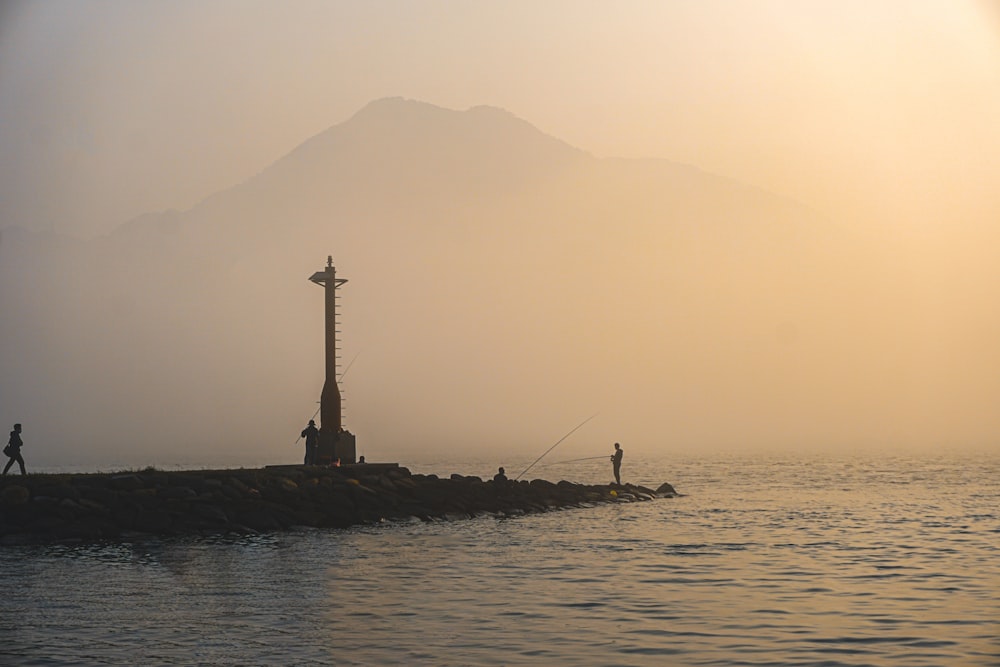 silhouette of person on body of water during daytime