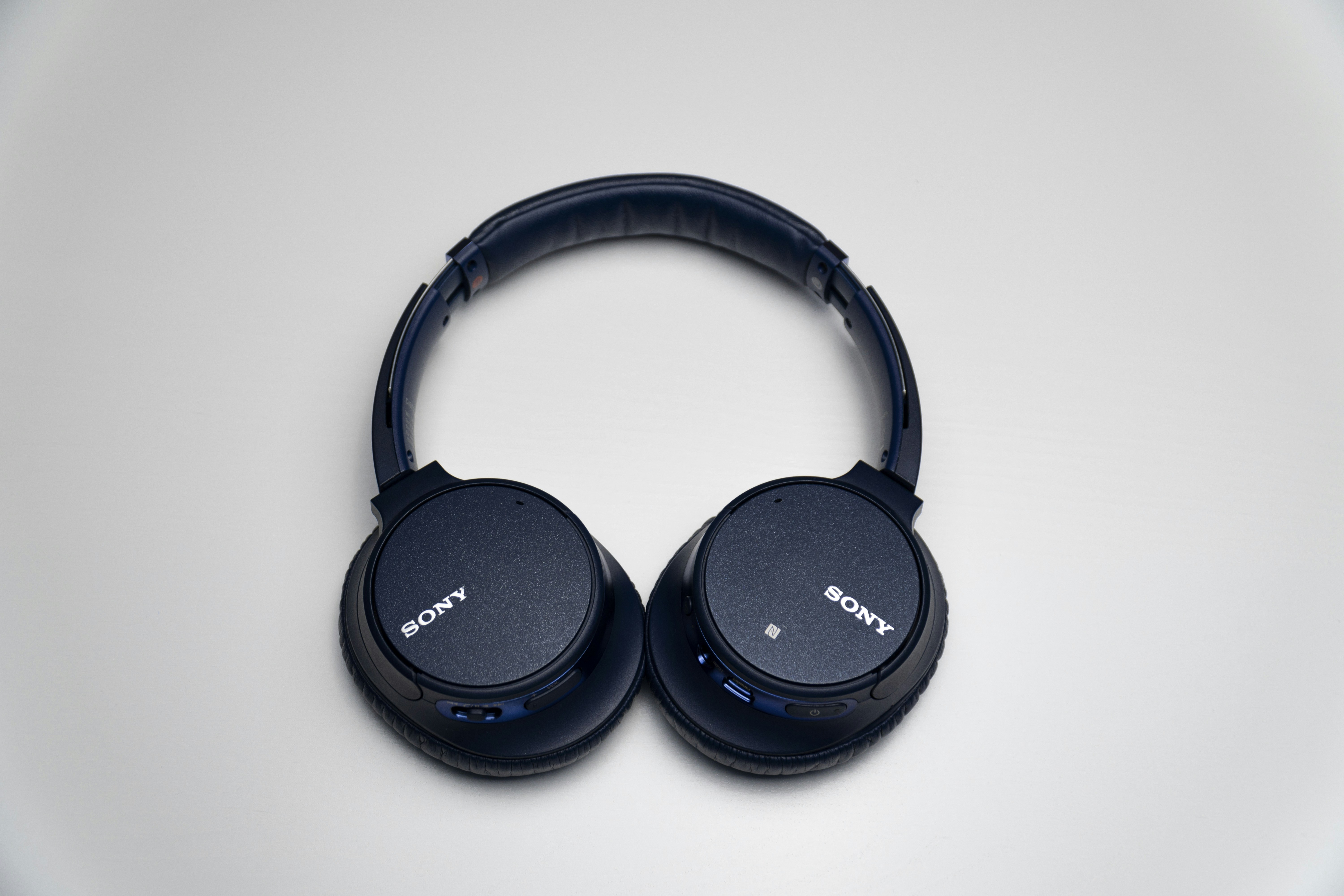black sony headphones on white surface