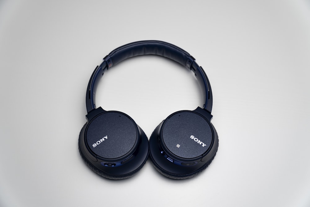black sony headphones on white surface