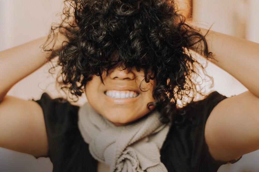 woman in black sleeveless shirt smiling