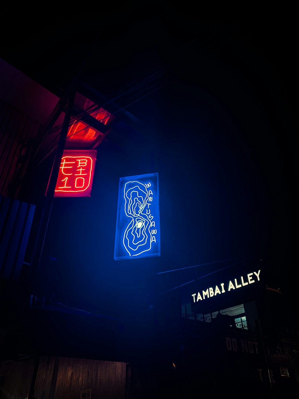 a neon sign is lit up in the dark