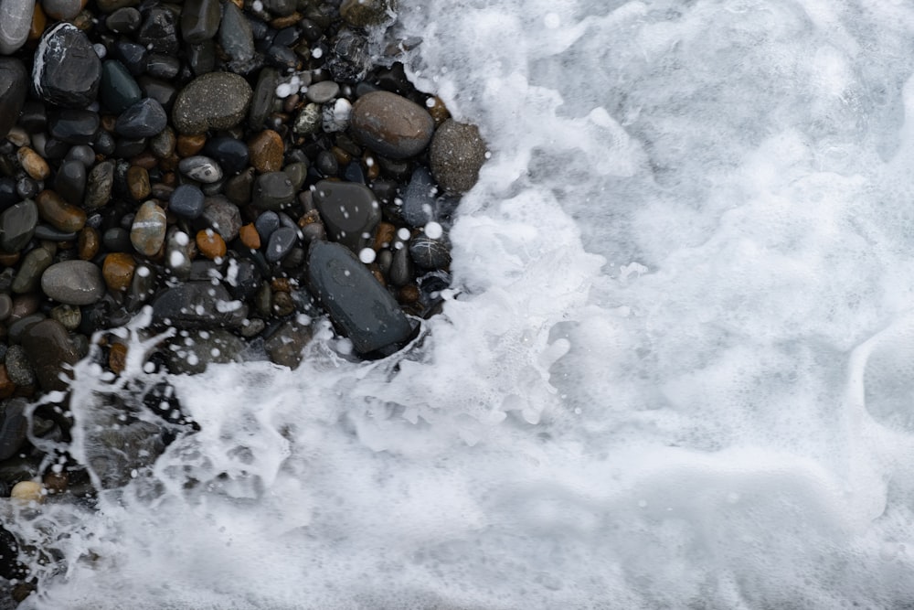 brown and black stones on snow covered ground