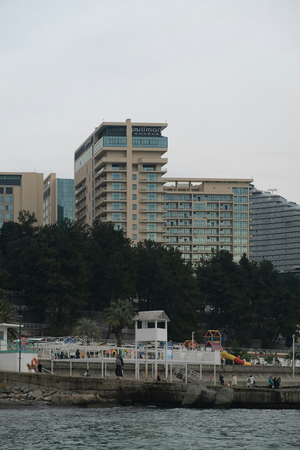 white and brown concrete building near green trees during daytime