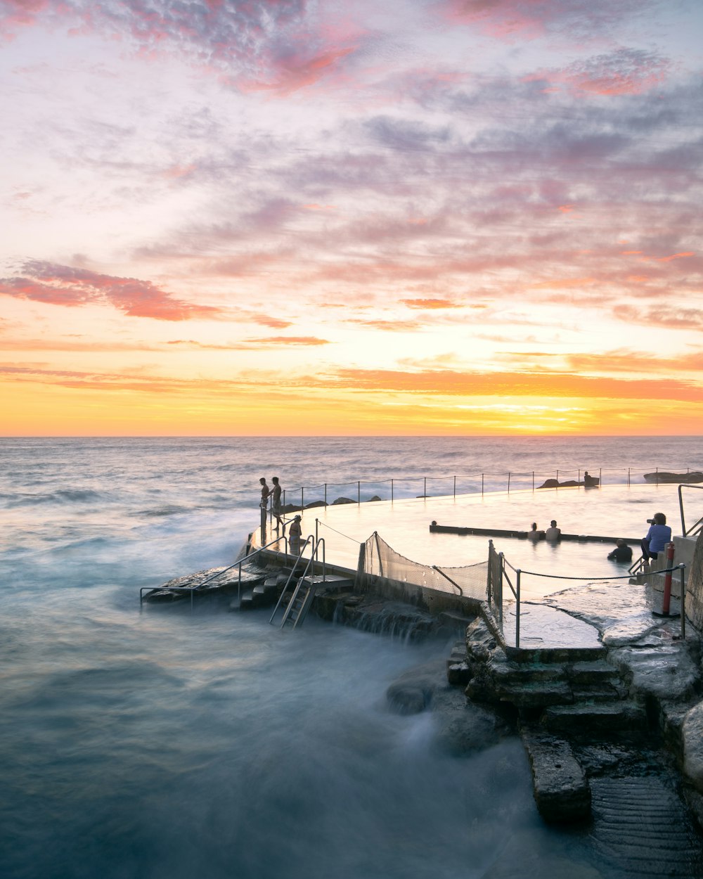 white and black boat on sea during sunset