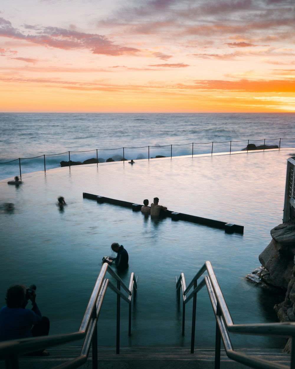 people on dock during sunset