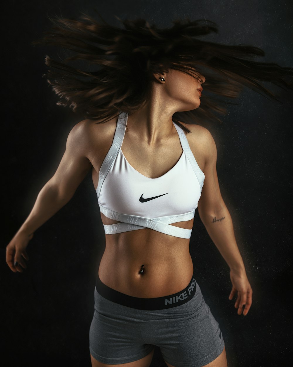 woman in white sports bra and black shorts