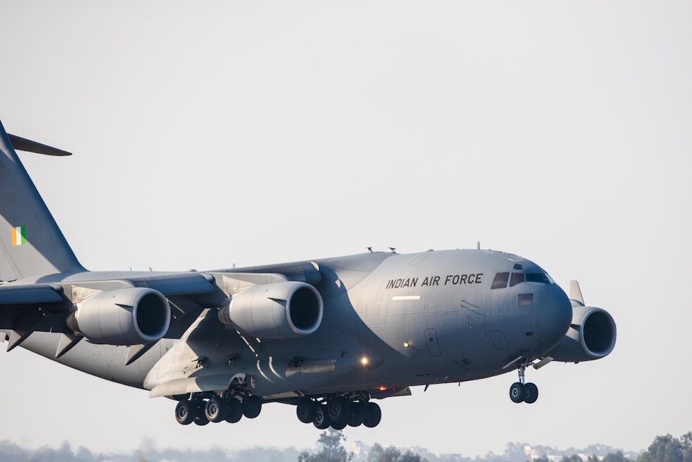 gray airplane under white sky during daytime