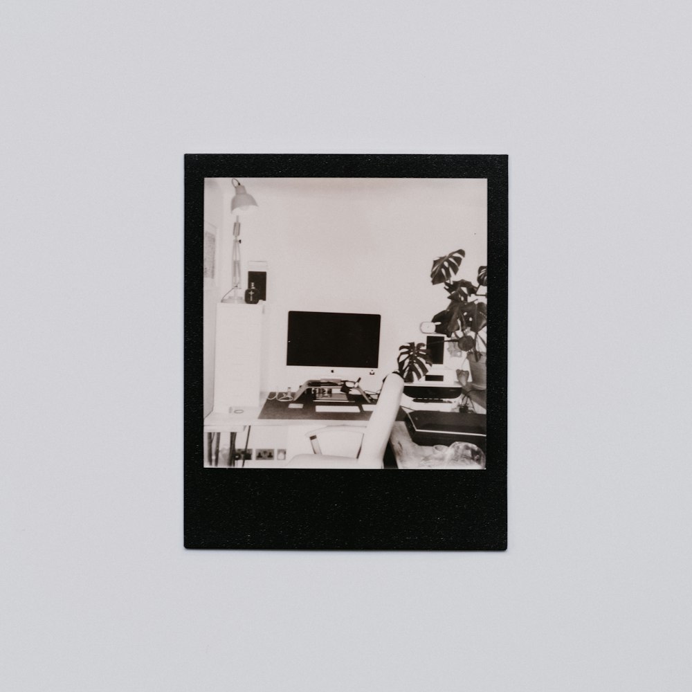 man in black and white shirt sitting on white chair